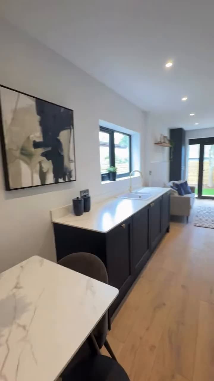 Walk-through of a refurbished Cardiff home: navy kitchen, oak floors and doors to the garden